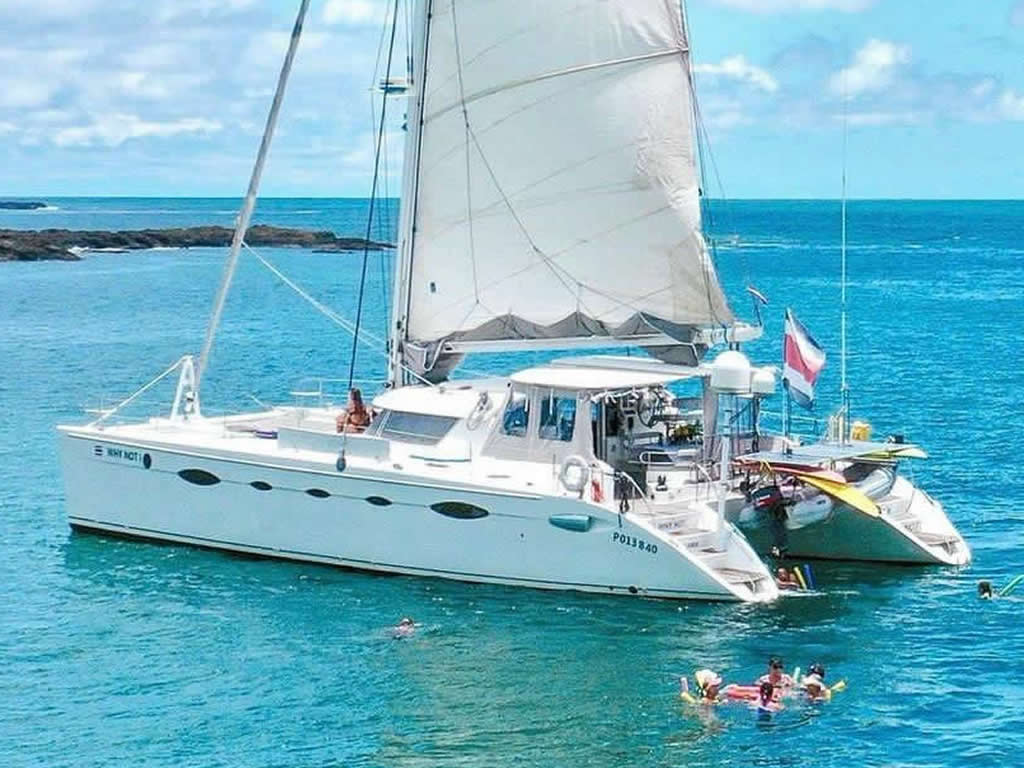 Why Not boat anchored in calm, turquoise water on a sunny day